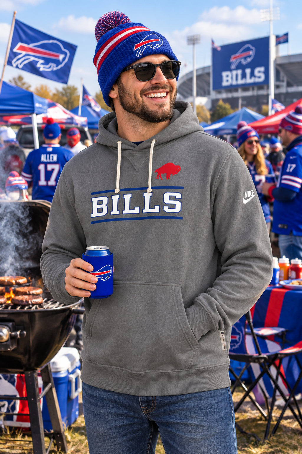 A gray Nike pullover hoodie featuring Buffalo Bills graphics, including a red buffalo logo and 'BILLS' text in white and blue on the chest, with a white Nike swoosh on the sleeve.
